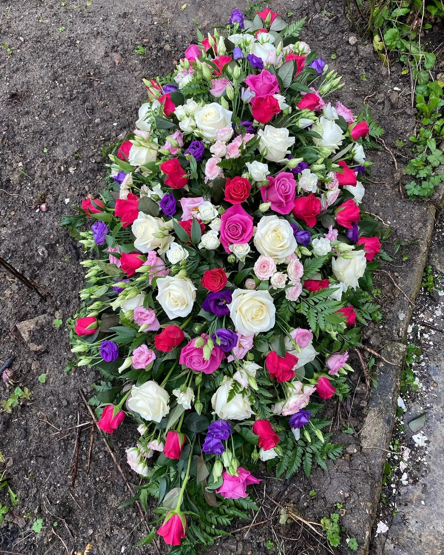 Pink, purple and white funeral flower tribute