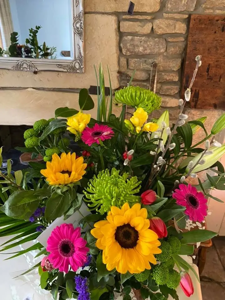 Colourful arrangement with sunflowers and pink gerberas